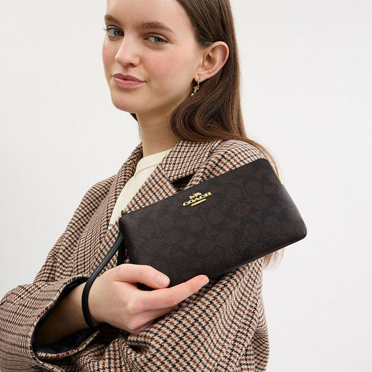 กระเป๋าคล้องมือผู้หญิง รุ่น Large Corner Zip Wristlet In Signature Canvas