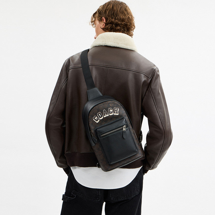กระเป๋าคาดอกผู้ชาย รุ่น West Pack In Signature Canvas With Varsity Graphic
