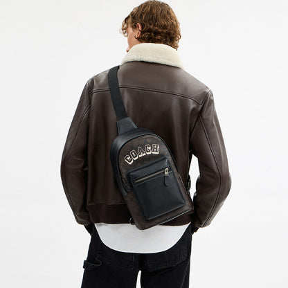 กระเป๋าคาดอกผู้ชาย รุ่น West Pack In Signature Canvas With Varsity Graphic